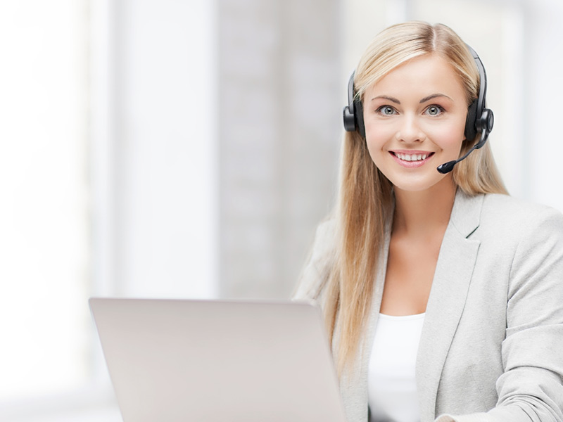 woman wearing a headset at a computer